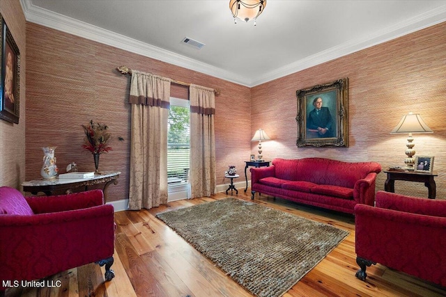 living room featuring crown molding and hardwood / wood-style flooring