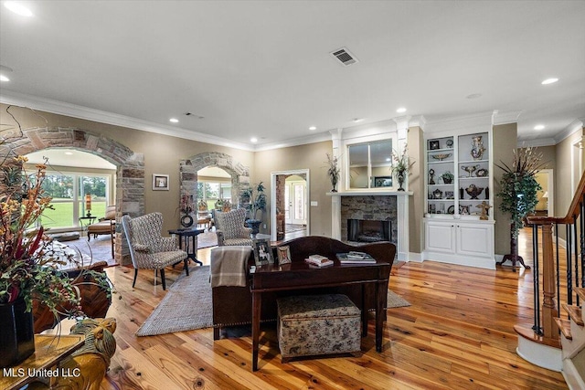 living room featuring ornamental molding and light wood-type flooring