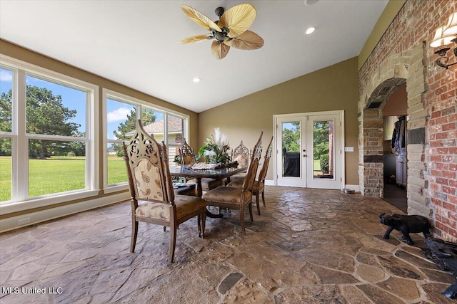 dining space featuring lofted ceiling, french doors, a healthy amount of sunlight, and ceiling fan