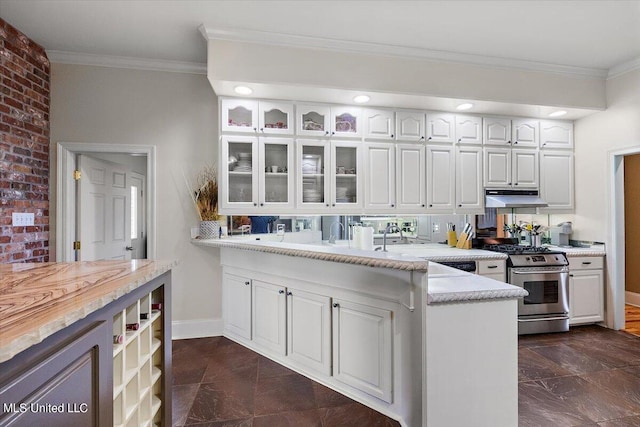 kitchen featuring white cabinetry, crown molding, brick wall, and stainless steel range