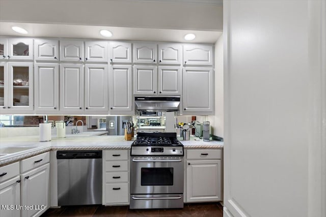 kitchen with appliances with stainless steel finishes, sink, and white cabinets