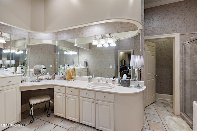 bathroom featuring a shower with door, vanity, and tile patterned flooring