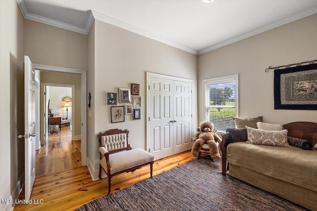 sitting room with crown molding and hardwood / wood-style flooring