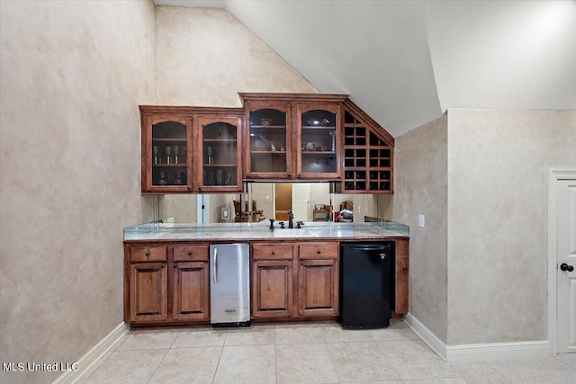 bar featuring light tile patterned flooring, vaulted ceiling, and black fridge