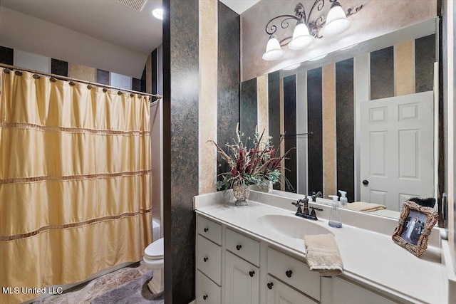 bathroom featuring vanity and toilet