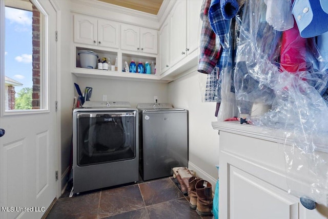 laundry room featuring cabinets and washer and clothes dryer