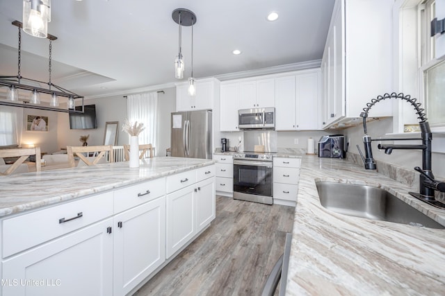 kitchen with white cabinetry, sink, pendant lighting, and appliances with stainless steel finishes