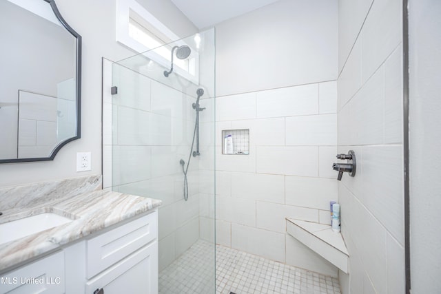 bathroom featuring an enclosed shower and vanity