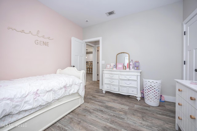 bedroom with hardwood / wood-style flooring