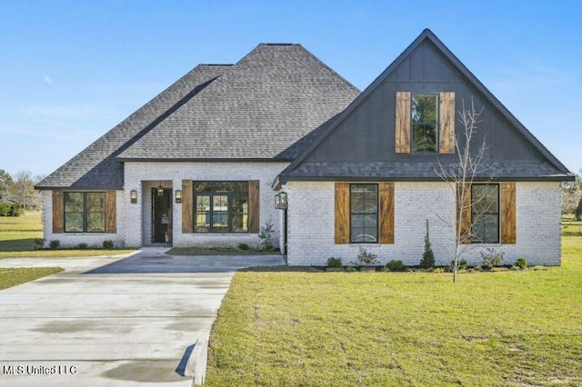 620 Old Savannah Dr, Long Beach, MS 39560 - view of front of house with brick siding, a front lawn, and a shingled roof