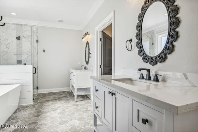 620 Old Savannah Dr, Long Beach, MS 39560 - full bathroom featuring crown molding, a shower stall, a soaking tub, two vanities, and baseboards
