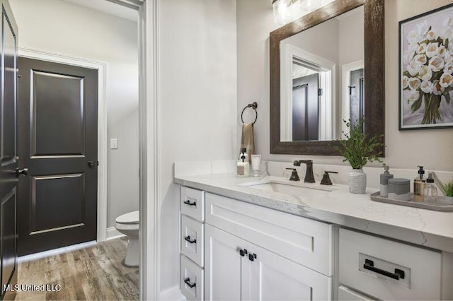 620 Old Savannah Dr, Long Beach, MS 39560 - bathroom with toilet, vanity, and wood finished floors