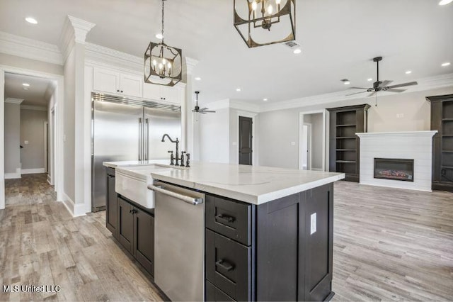 620 Old Savannah Dr, Long Beach, MS 39560 - kitchen with ceiling fan, stainless steel appliances, white cabinets, a center island with sink, and recessed lighting