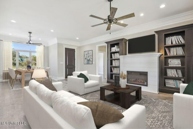 620 Old Savannah Dr, Long Beach, MS 39560 - living area with a ceiling fan, recessed lighting, wood finished floors, a glass covered fireplace, and crown molding