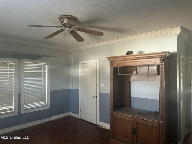 interior space featuring ceiling fan, dark wood-type flooring, a textured ceiling, and ornamental molding