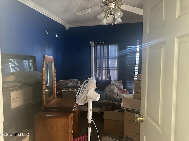 bedroom with ceiling fan, ornamental molding, and a textured ceiling