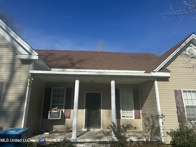 property entrance with covered porch and cooling unit