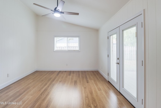 unfurnished room with a ceiling fan, light wood-style floors, baseboards, and lofted ceiling