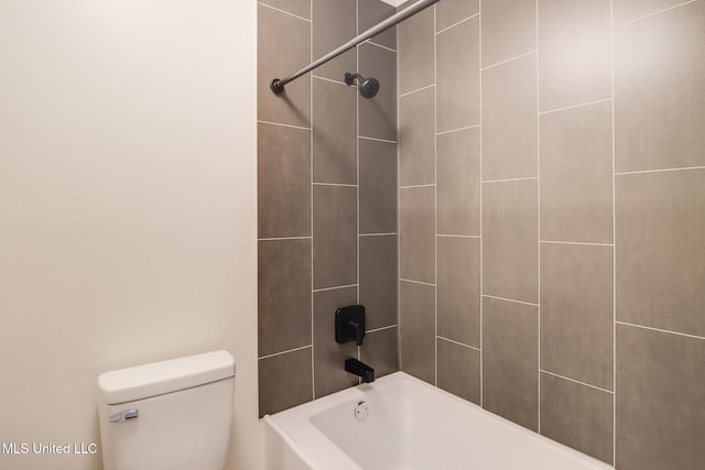 bathroom with toilet and bathing tub / shower combination