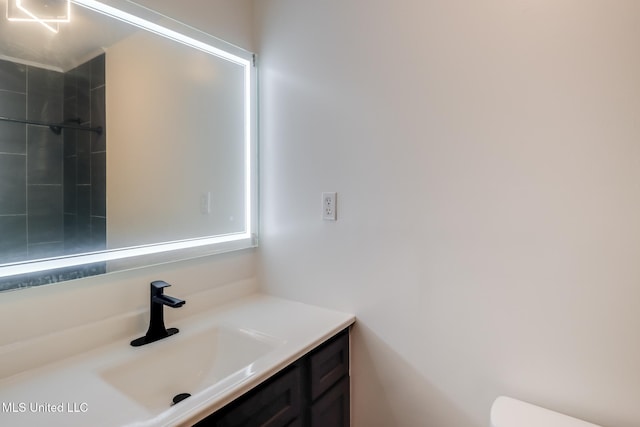 bathroom featuring toilet and vanity