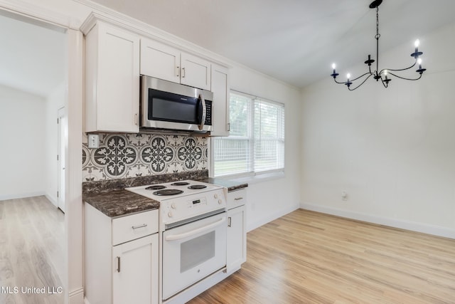 kitchen with a notable chandelier, white electric stove, stainless steel microwave, decorative backsplash, and light wood-style floors