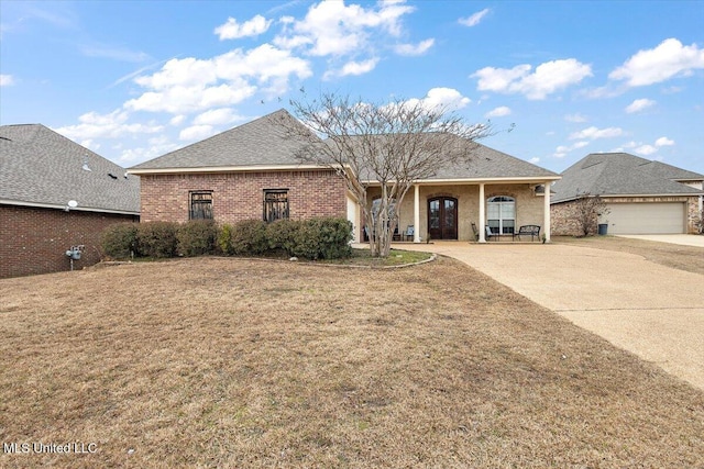 view of front of property featuring a garage and a front lawn