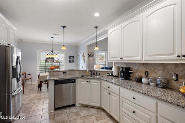 kitchen featuring sink, appliances with stainless steel finishes, white cabinetry, decorative light fixtures, and kitchen peninsula