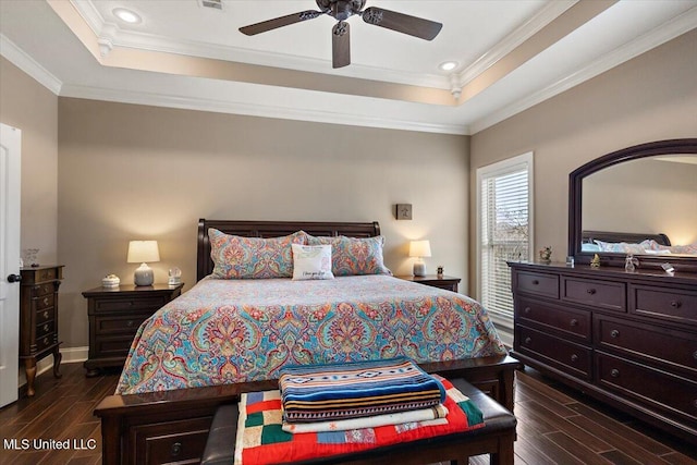 bedroom featuring crown molding, a tray ceiling, and ceiling fan