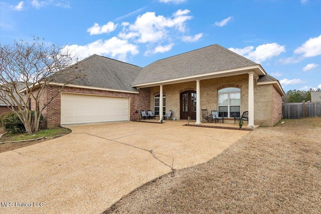 view of front of property featuring a garage and covered porch