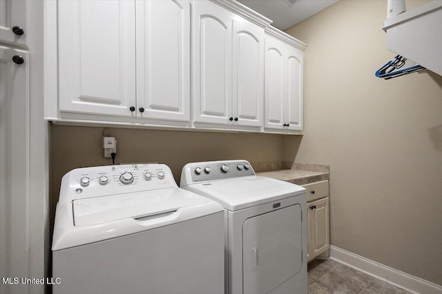 laundry area featuring cabinets and independent washer and dryer