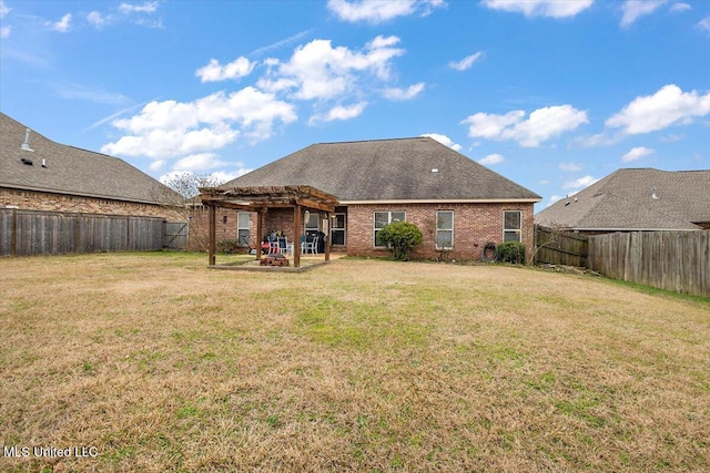 back of house with a yard, a pergola, and a patio area