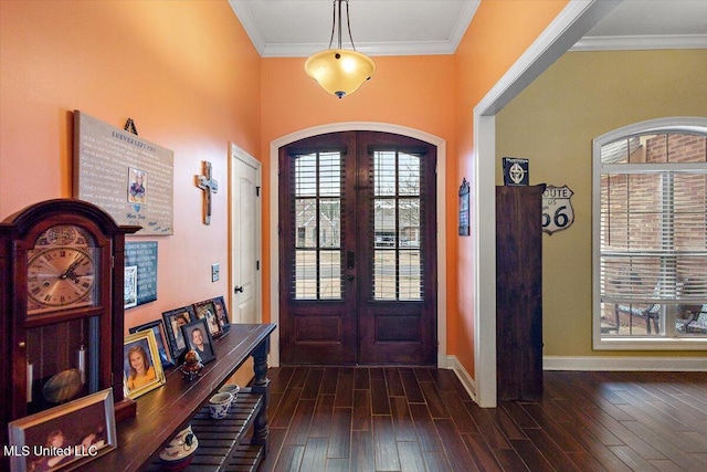 entrance foyer with dark hardwood / wood-style flooring, ornamental molding, and french doors