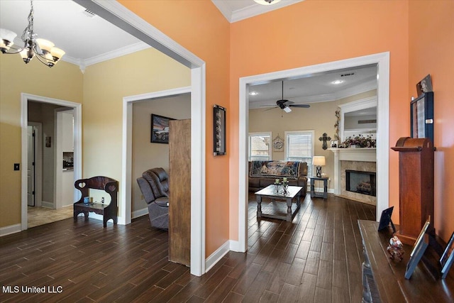 hall with dark hardwood / wood-style flooring, ornamental molding, and a chandelier