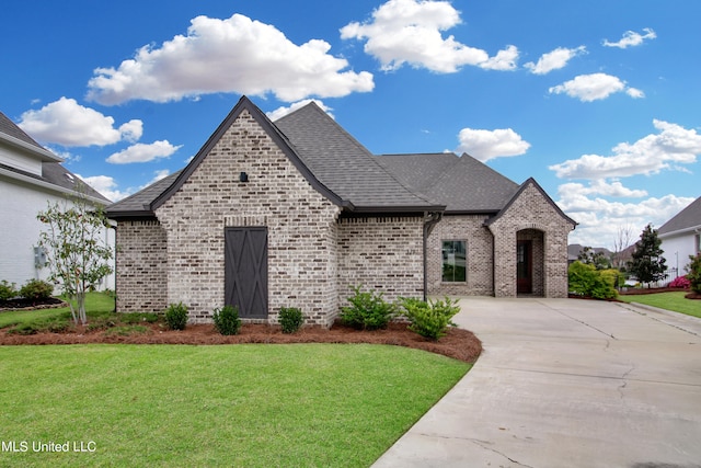 french provincial home featuring a front lawn