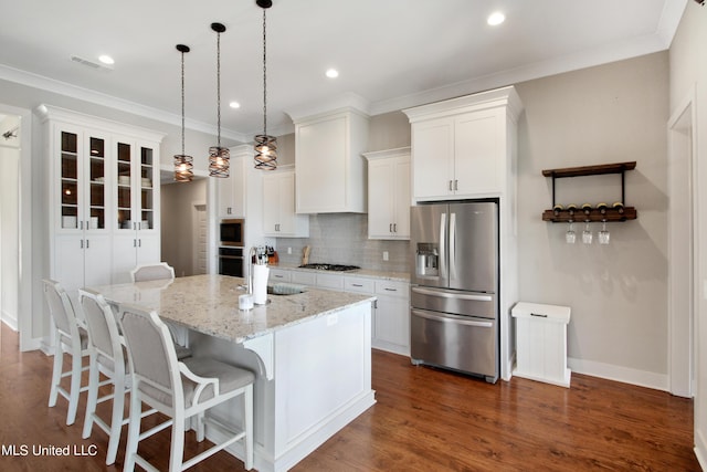 119 Shore View Dr, Madison, MS 39110 - kitchen with stainless steel appliances, backsplash, white cabinets, a center island with sink, and crown molding