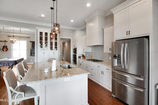 kitchen with a kitchen island with sink, dark hardwood / wood-style floors, sink, white cabinetry, and appliances with stainless steel finishes