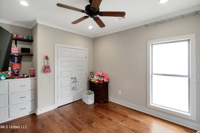 bedroom with ornamental molding, hardwood / wood-style floors, and ceiling fan