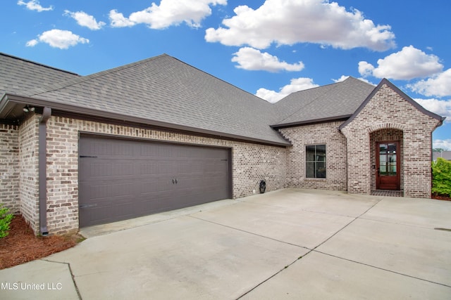 french country style house featuring a garage