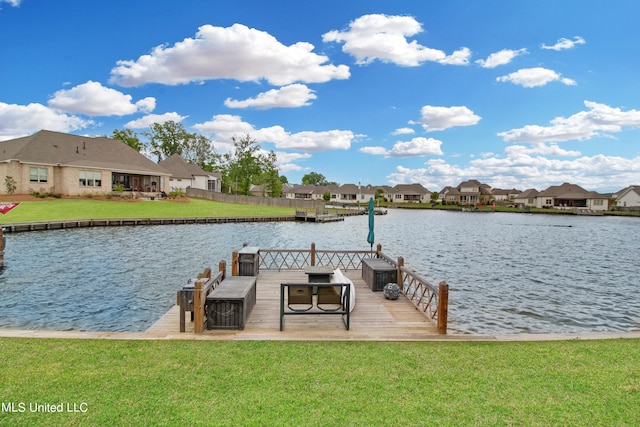 view of dock with a water view and a lawn