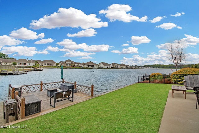 view of dock featuring a water view and a lawn