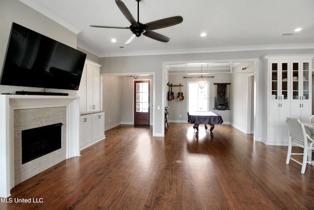 unfurnished living room with crown molding, billiards, dark hardwood / wood-style flooring, and ceiling fan