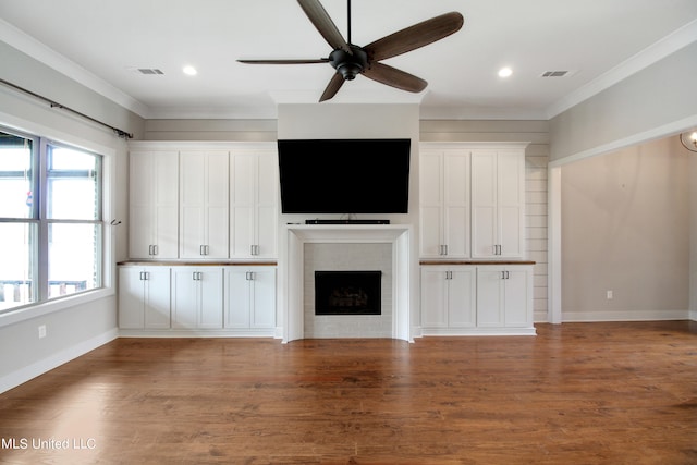 unfurnished living room with ceiling fan, ornamental molding, and dark hardwood / wood-style floors