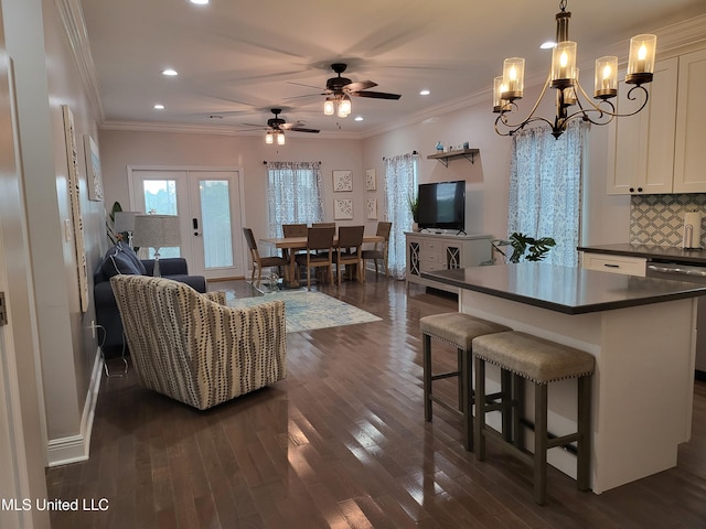 4024 Honshu St, Bay Saint Louis, MS 39520 - living area with ceiling fan with notable chandelier, ornamental molding, dark wood finished floors, and recessed lighting