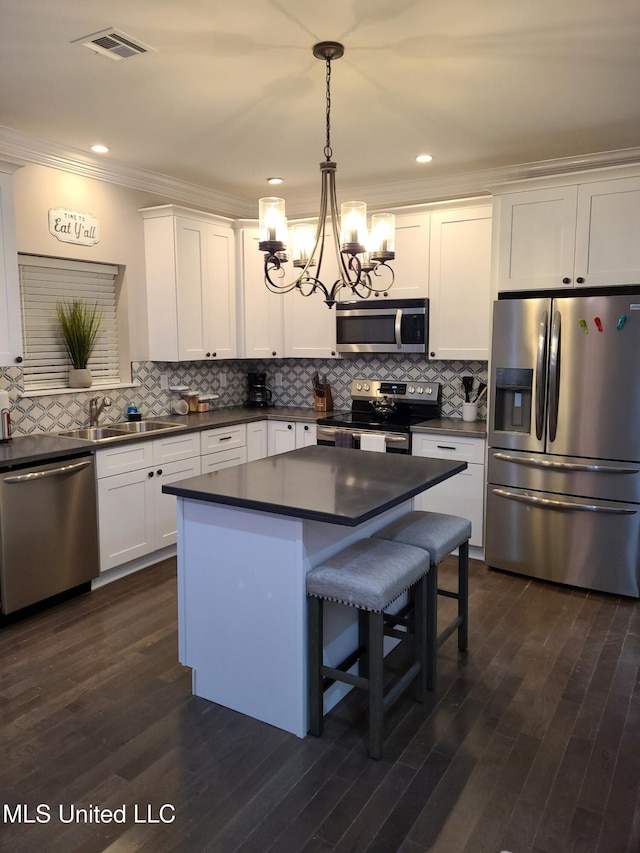 4024 Honshu St, Bay Saint Louis, MS 39520 - kitchen with a sink, dark countertops, a chandelier, and stainless steel appliances