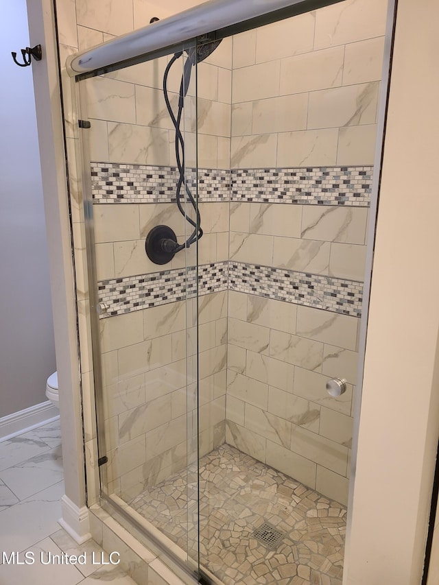 4024 Honshu St, Bay Saint Louis, MS 39520 - bathroom featuring a shower stall, marble finish floor, and toilet