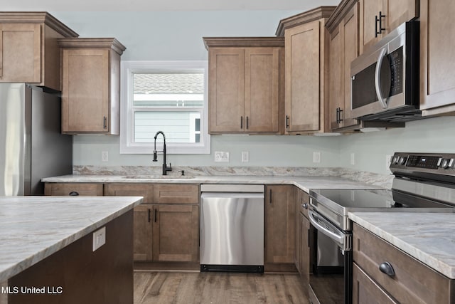 kitchen with dark hardwood / wood-style floors, sink, and appliances with stainless steel finishes