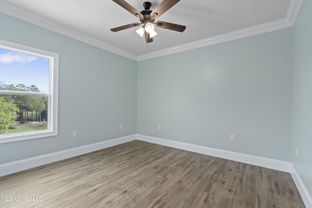 empty room with crown molding, a healthy amount of sunlight, and light hardwood / wood-style floors