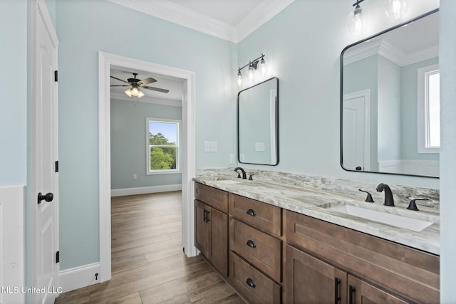 bathroom featuring wood-type flooring, vanity, ceiling fan, and crown molding