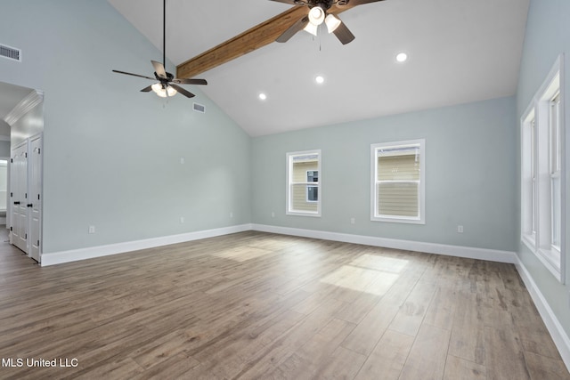 unfurnished living room featuring beam ceiling, hardwood / wood-style flooring, high vaulted ceiling, and plenty of natural light