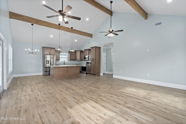 kitchen featuring light hardwood / wood-style floors, beamed ceiling, pendant lighting, and appliances with stainless steel finishes